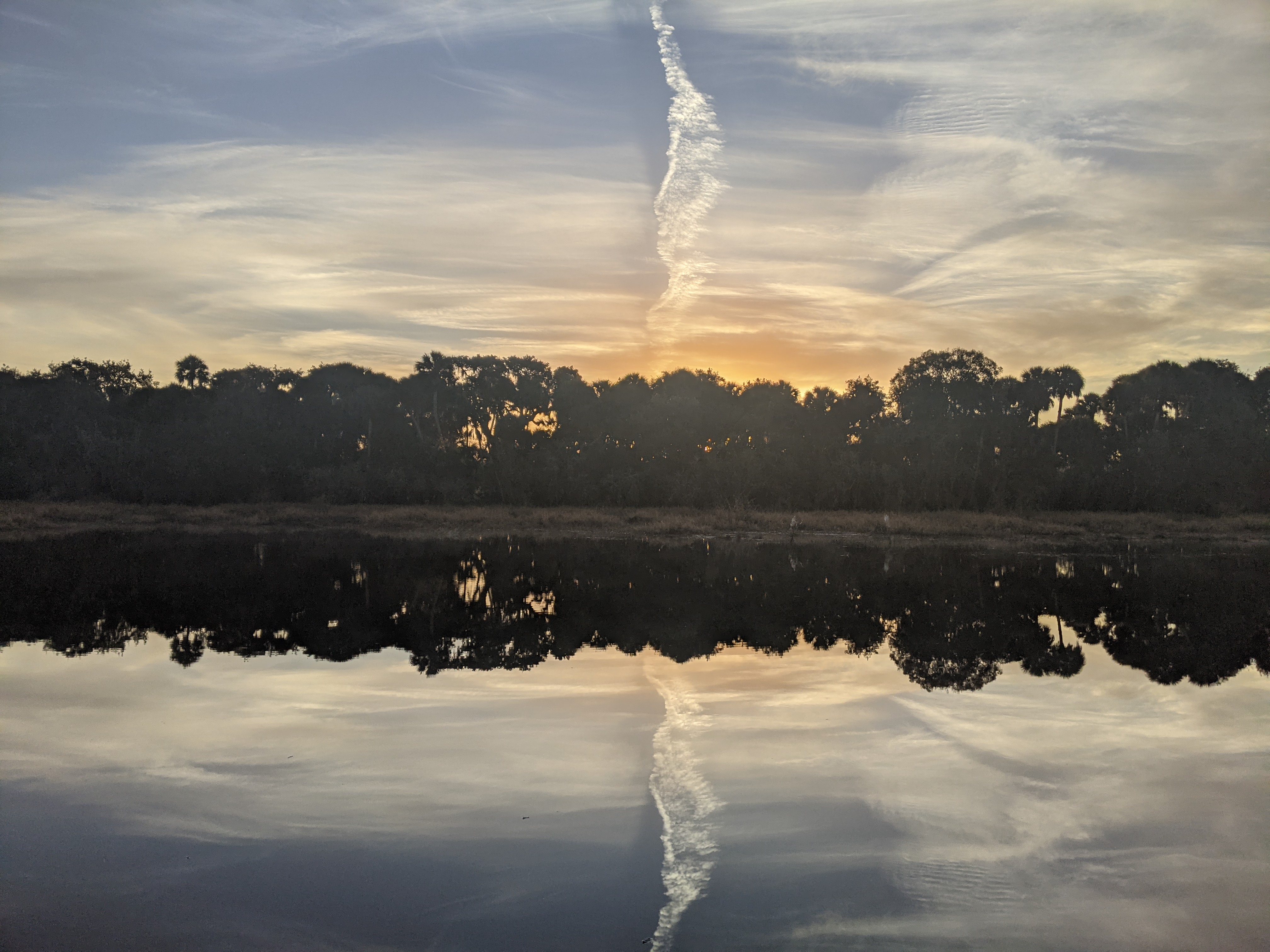 sunrise reflected in the marsh, reflexive appearance from clouds